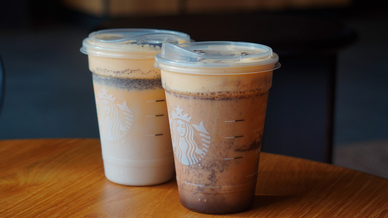 Side view of Starbucks' Snoopy Cookie Frappuccino and Charlie Brown Mocha Frappuccino (left to right).