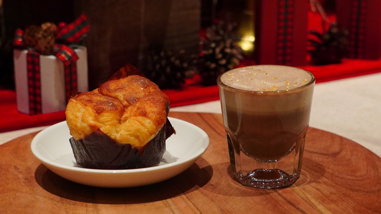 Starbucks Cinnamon Pull-Apart Bread and Caramel Miso Hot Chocolate on a wooden tray in front of wrapped gifts