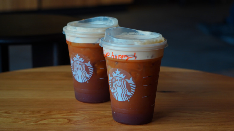 Side view of Starbucks' Caramel Aerocano and Aerocano (left to right).