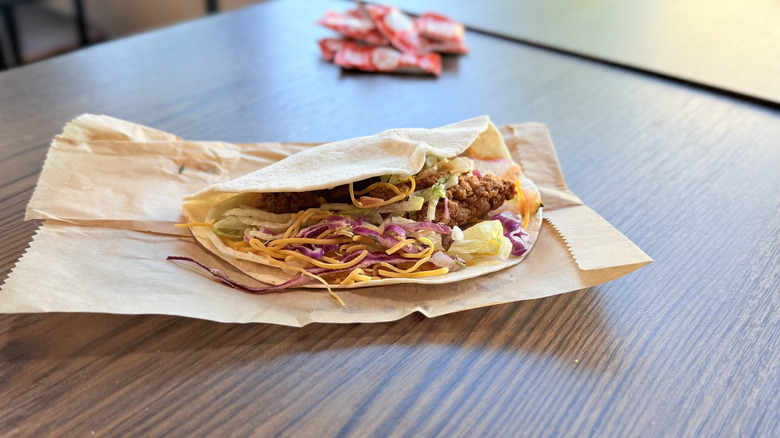 Slightly open taco sitting on a table