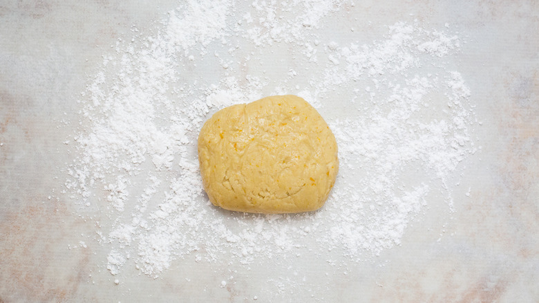 dough ball on sugar-dusted counter