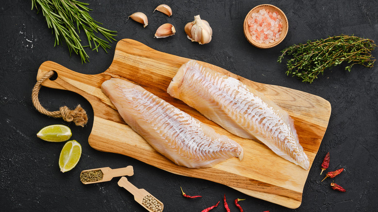 fish fillets on wooden cutting board