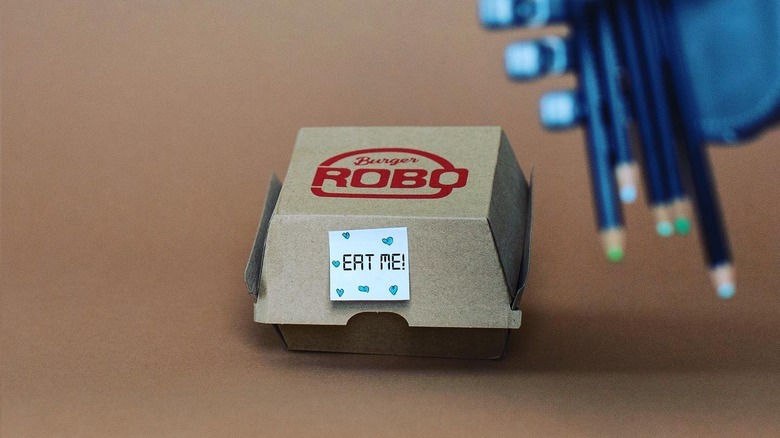 A RoboBurger box with a sticker that reads 'Eat Me!'