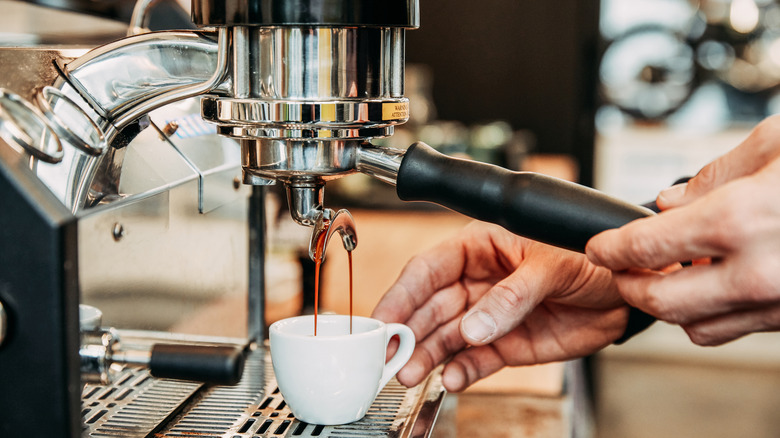 Barista making coffee in an espresso machine