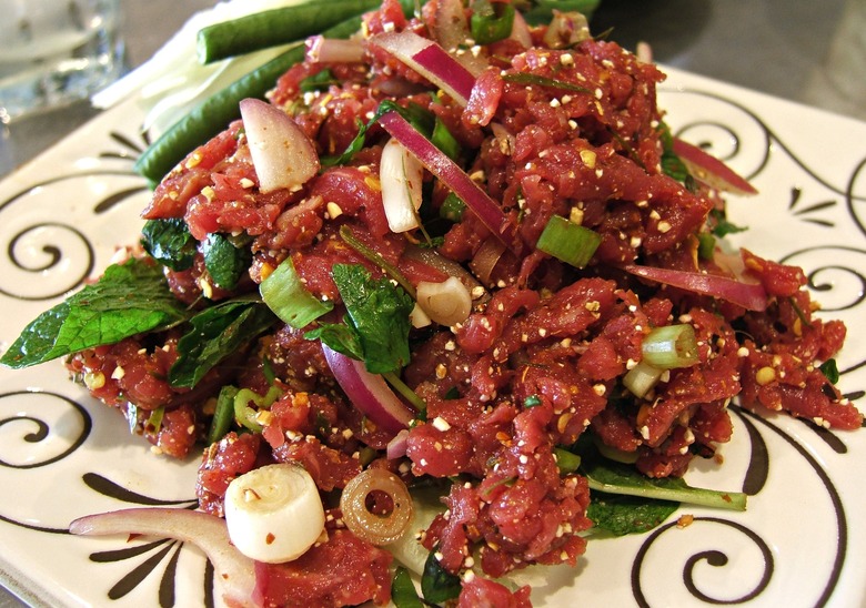 Chili powder, onion, mint and lime juice give flavor to the Thai version of tartare, num tok koy.