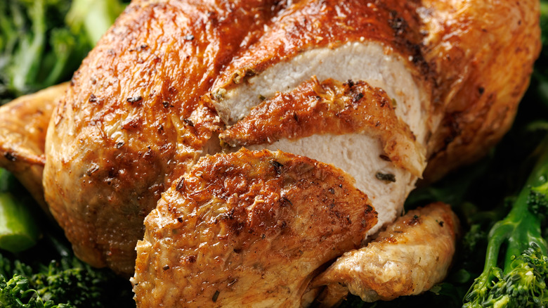 A close up of roast chicken with a nicely browned skin