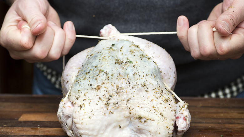A chicken being trussed