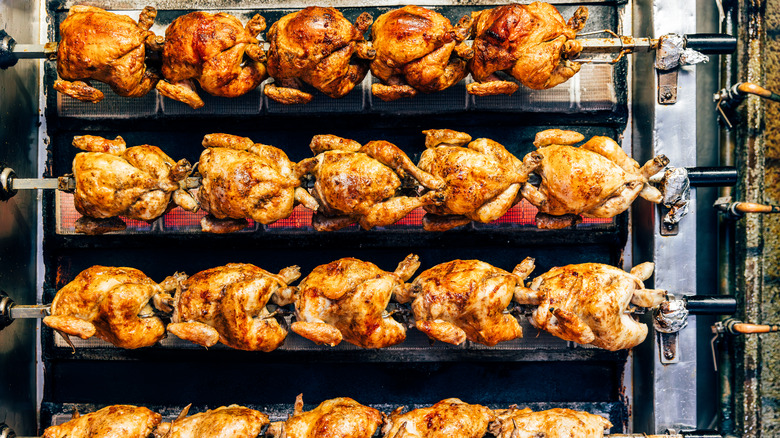 rotisserie chickens being cooked