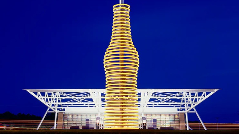The exterior of Pop's 66 at night, the 66 ft cola bottle is light up