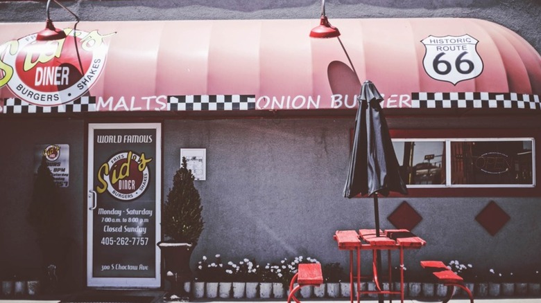 The exterior of Sid's Diner, it has a red awning