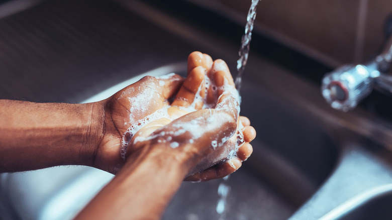 Person washing hands thoroughly