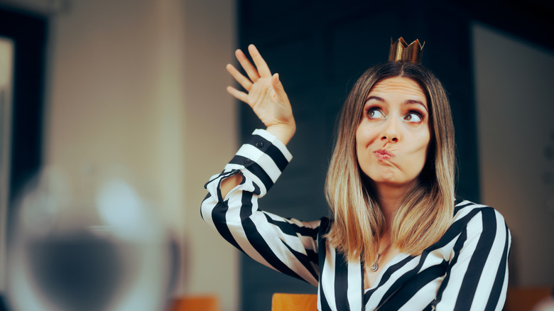 Woman waving her hand around in a restaurant