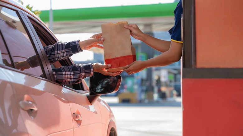 Customer receiving drive-thru food