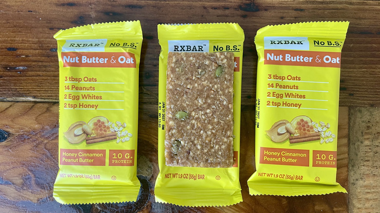 RX Bar Nut Butter & Oat Honey Cinnamon Peanut Butter protein bars on a wooden tabletop