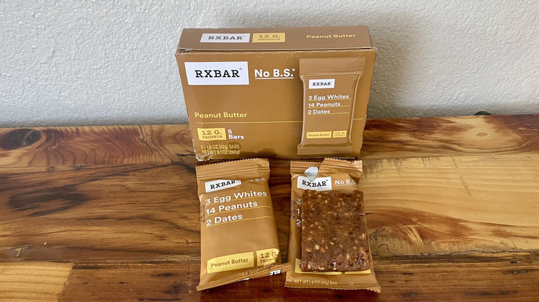 Box of RX Bar's Peanut Butter protein bars with two outside of the box