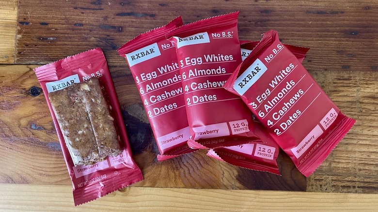 Several RX Bar Strawberry protein bars on a wooden tabletop
