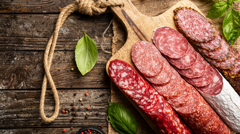 Assorted salamis with basil and peppercorns