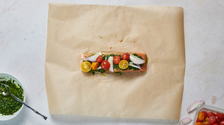 salmon with tomatoes on parchment