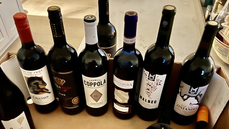 A variety of wines from Sam's Club sit in an open cardboard box