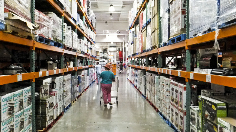 Shopper walking down a Costco aisle