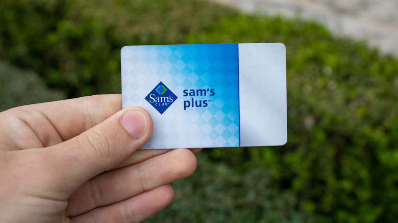 Hand holding Sam's Club membership card