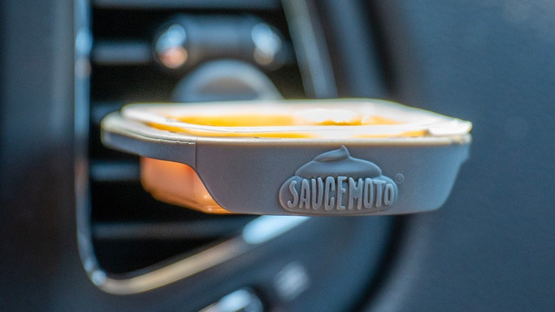 Saucemoto dip clip holder attached to car air conditioner vent