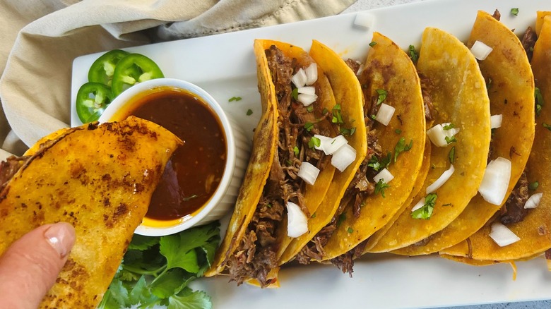 saucy birria tacos on plate 