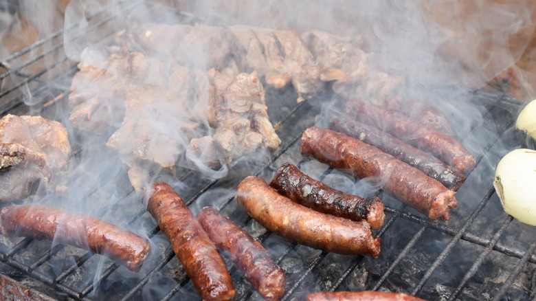 sausages on grill with smoke