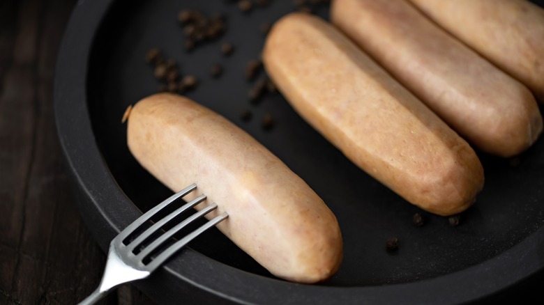 pricking sausages with a fork
