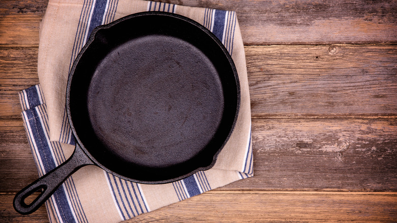 A cast iron pan on a tablecloth.