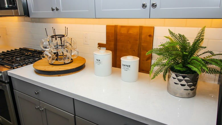 Kitchen counter with lazy Susan holding glass mugs