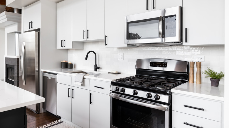 An unpersonalized white kitchen with generic appliances