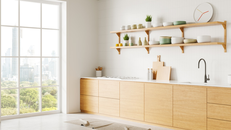 A minimalist-style kitchen with open shelves and white walls