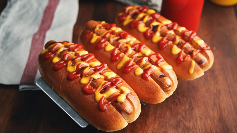 three hot dogs with ketchup and mustard