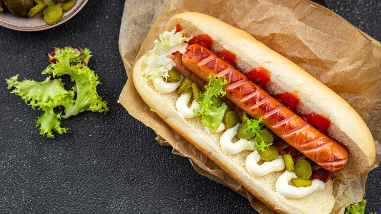 scored hot dog with mayo and ketcup