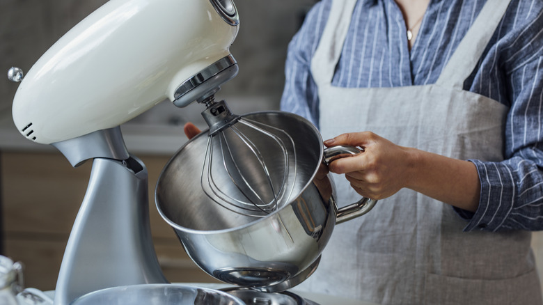 woman using a KitchenAid mixer