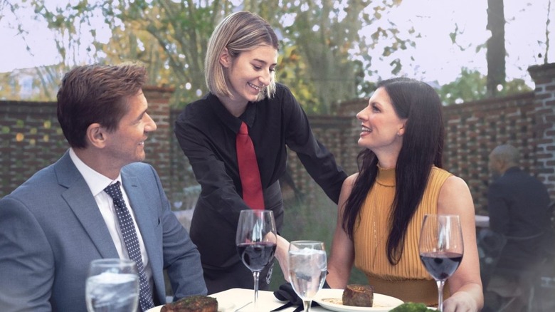Ruth's Chris female server with guests