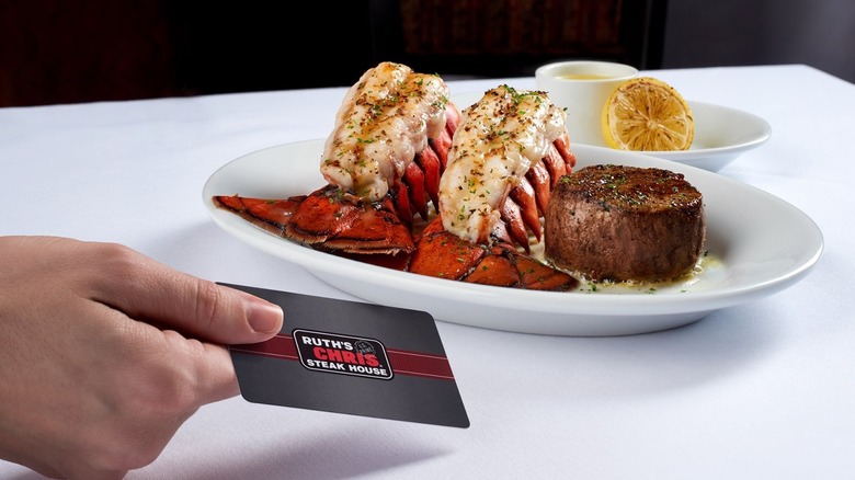 lobster and steak at Ruth's Chris Steakhouse with hand holding gift card 