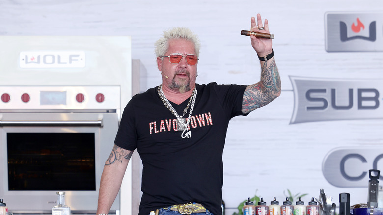 Chef Guy Fieri greets the crowd at a publicity event