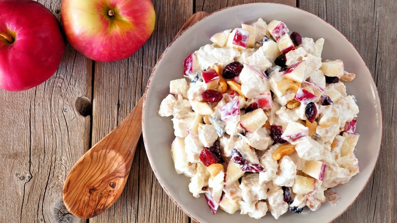 Chicken salad next to apples