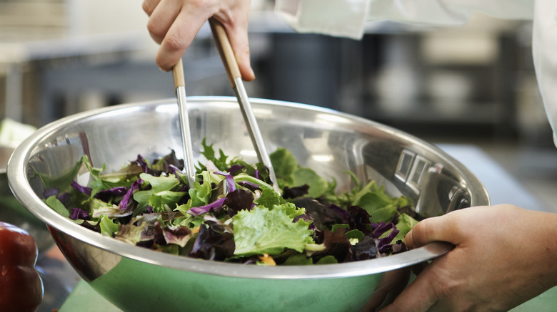 tossing salad with tongs
