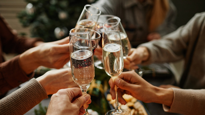 Group of people clinking Champagne glasses