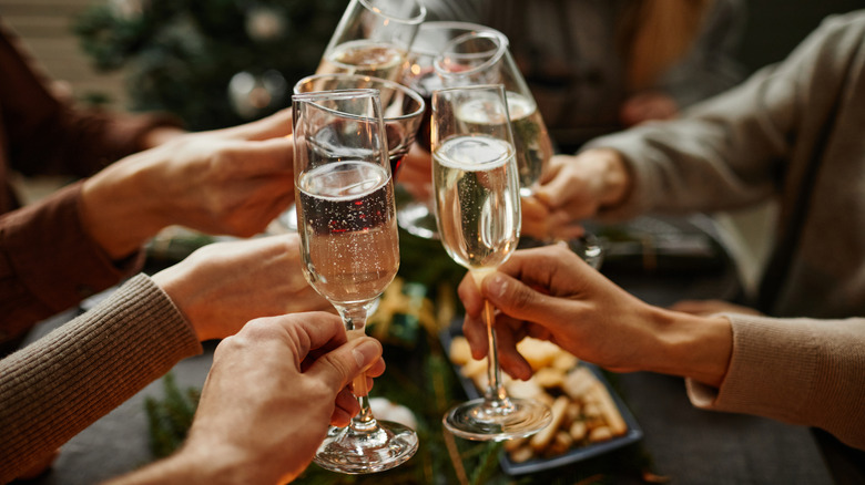 Group of people clinking Champagne glasses