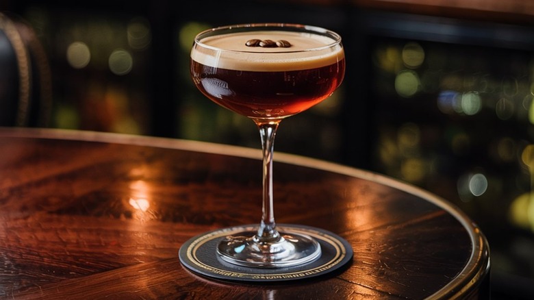 An espresso martini sitting on a bar