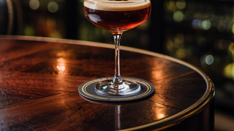 An espresso martini sitting on a bar