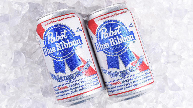 Two cans of PBR on a bed of ice