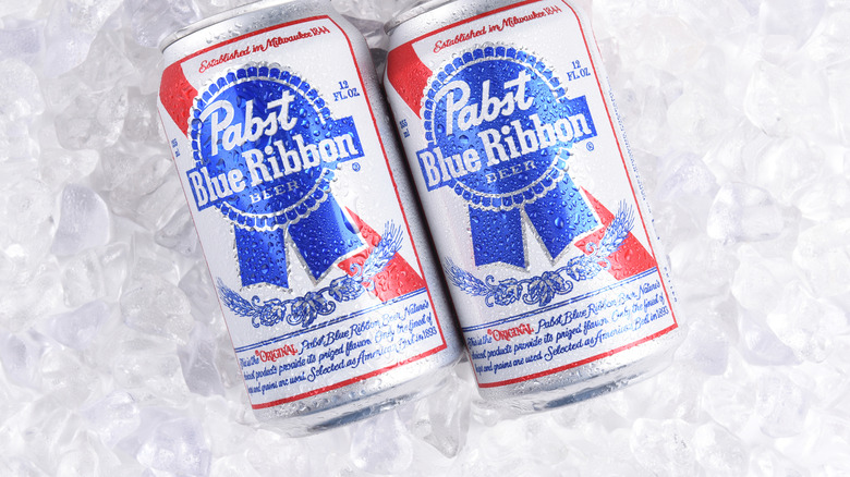 Two cans of PBR on a bed of ice