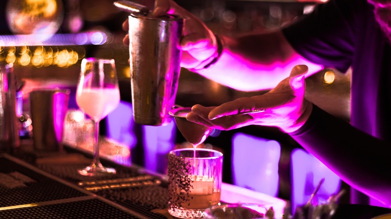 Bartender crafting cocktail in a sultry lounge