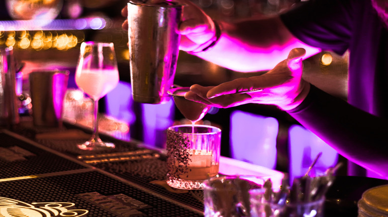 Bartender crafting cocktail in a sultry lounge