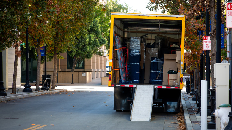 Open moving truck full of large appliances